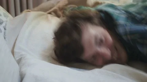 Exhausted young man falling asleep on bed, feeling no energy after hard working Stock Footage 154138431