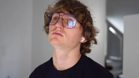 Exhausted young man tilts his head back with a dazed expression as if emotionall Stock Footage 312981826