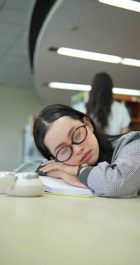 Exhaustion in the Library 스톡 동영상 332390138