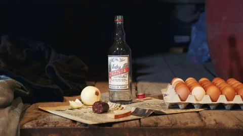 Exhibit of old peasant table with vodka, sausage, onion, eggs and other things Stock Footage 153091395