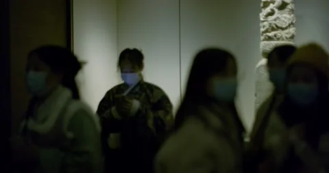 Exhibition groups walks away from statue Stock Footage 143392458