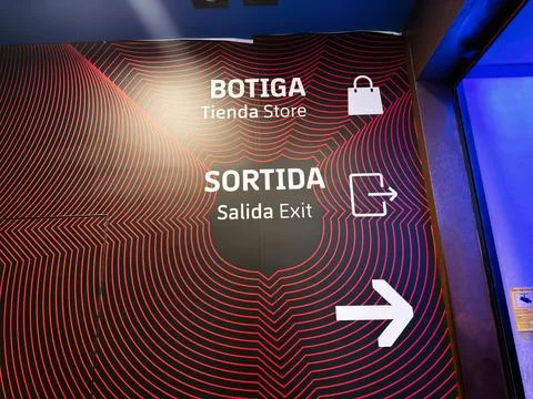 Exit and store signage with bold red wave pattern and arrow indicating Sort.. Stock Photos