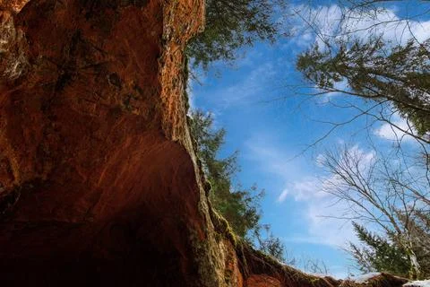 Exit from the cave, view of the sky Stock Photos