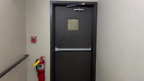 Exit door with fire pull and fire extingisher Stock Footage 280276532