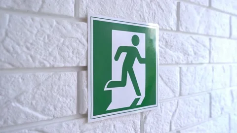 Exit emergency sign in 4K slow motion. An exit sign hangs on a wall. 4k stock Stock Footage 156423219