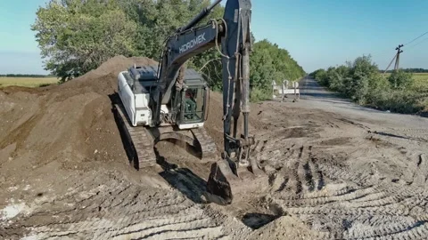 Exit of the excavator from the mountain during the construction of the road Stock Footage 191517313