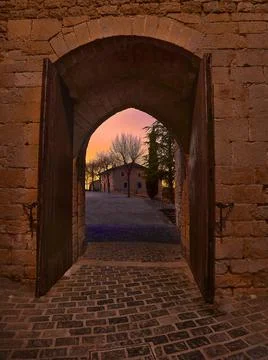 Exit to the field through the medieval gate Stock Photos
