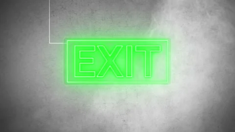 Exit in green color neon real signboard on wet wall background. Stock Footage 220856485