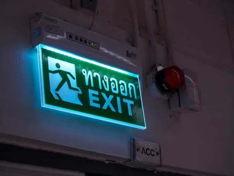 Exit light box (with Thai text) to define this is the way to run out when occ Stock Photos