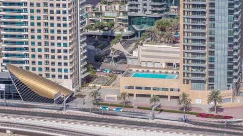 Exit from metro station and traffic on a road in Dubai marina timelapse Stock Photos