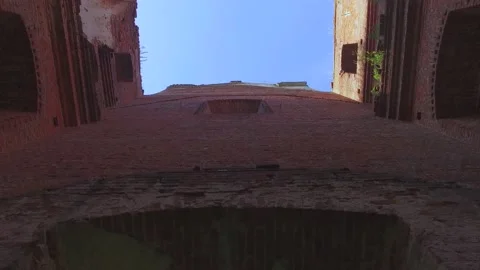 Exit from the middle out of the old Catholic church with a ruined roof Stock Footage 131226064