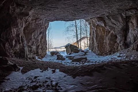 Exit from a mountain cave in winter Stock Photos