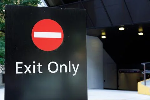 Exit Only sign with red no entry symbol at a parkade ramp Фото