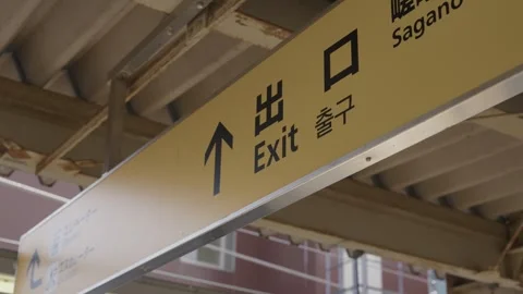 Exit sign with arrow at Sagano train station in Arashiyama Kyoto Stock Footage 337912898