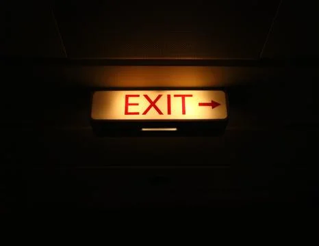 Exit sign on black background Stock Photos
