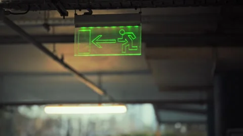 Exit sign guiding people towards safe evacuation direction with clear symbol Stock Footage 331350505