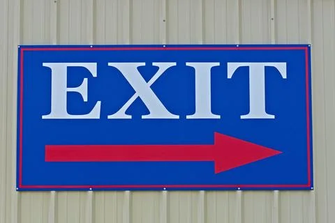 Exit Sign with a Red Arrow on a Blue Background Stock Photos