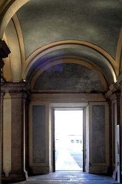 Exit through an open door in an old marble building. There an arch over the d Stock Photos