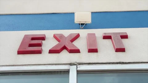 Exit word caption writing text in red sign on building wall above windows Stock Footage 250275435