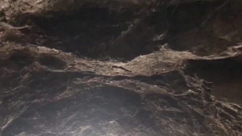 Exiting cave top view Vídeos de archivo 76504423