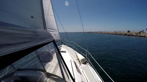 Exiting Harbor by jetty under full sail in California Stock Footage 65963642