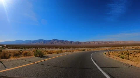 Exiting the highway onto a different one during a drive through the Mojave Stock Footage 152144850
