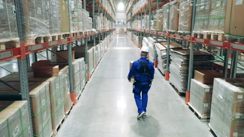 Exoskeleton, exosuit, robotic technology concept. Male worker takes a box away Stock Footage 159345520