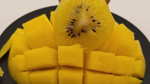 Exotic cut yellow mango delicious and kiwi close-up Stock Footage 325124016