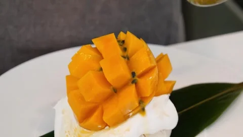 Exotic Dessert Presentation with Mango, Sticky Rice, and Coconut Ice Cream Stock Footage 331781704