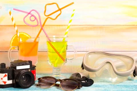 Exotic drinks, camera and diving mask Stock Photos