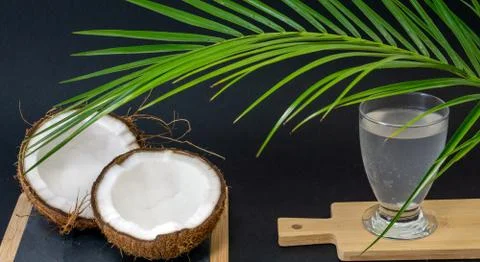 Exotic fruit Coconut, two halves of fruit in the shell, dark background Stock Photos