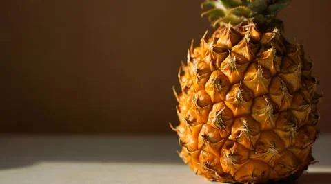 Exotic fruit pineapple on white table. Top view, copy space. Hard light, shadow Stock Photos