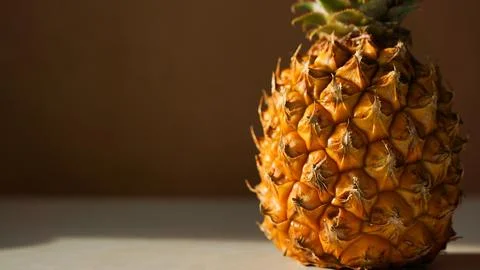 Exotic fruit pineapple on white table. Top view, copy space. Hard light, shad Foto stock