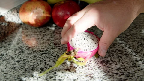 Exotic fruit pitahaya is placed on table in rays of setting sun. dragon fruit Stock Footage 221152279