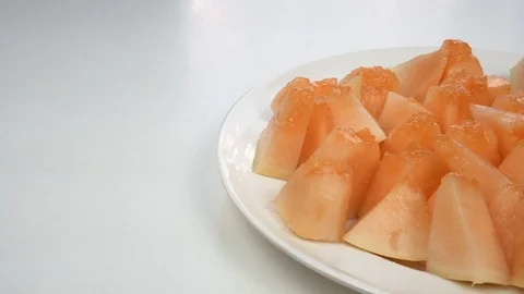 Exotic melon fruit close-up. Sliced melon on a white background Stock Footage 121200797