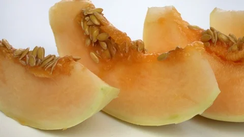 Exotic melon fruit close-up. Sliced melon on a white background Stock Footage 121200811