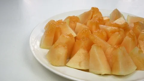 Exotic melon fruit close-up. Sliced melon on a white background Stock Footage 121299630