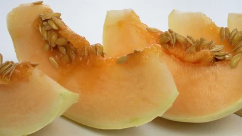 Exotic melon fruit close-up. Sliced melon on a white background Stock Footage 121299648