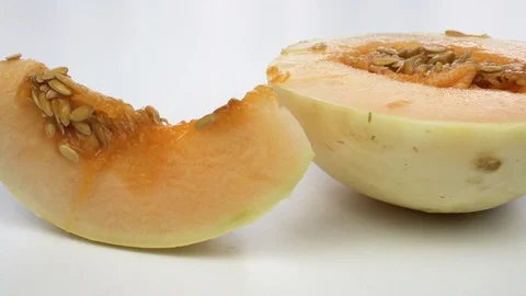 Exotic melon fruit close-up. Sliced melon on a white background Vídeo Stock 121320674