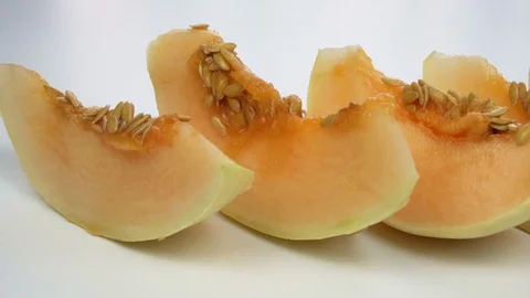 Exotic melon fruit close-up. Sliced melon on a white background Видео 121399657