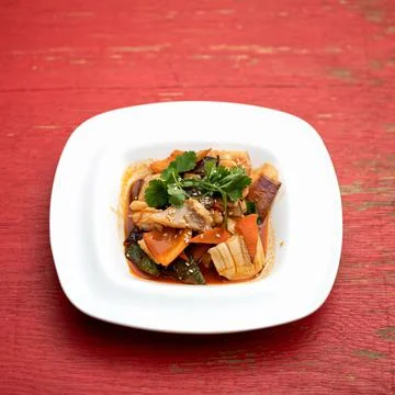 Exotic oriental dish with crab meat. Plate of pan-asian food on pink wooden Stock Photos