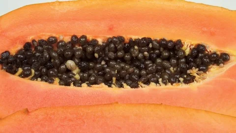 Exotic papaya fruit close-up. Cut into two parts papaya with black seeds. Stock Footage 121200465