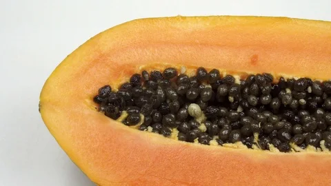 Exotic papaya fruit close-up. Cut into two parts papaya with black seeds. 動画素材 121200519