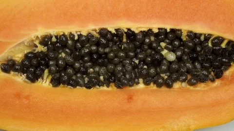 Exotic papaya fruit close-up. Cut into two parts papaya with black seeds. 스톡 동영상 121400079