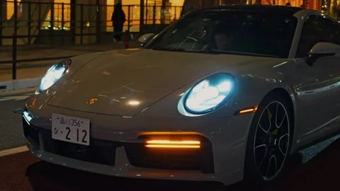 Exotic Performance Car Detail Shot With Illuminated Headlights And Urban Night Stock Footage 339200748