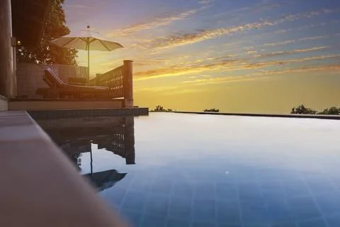 Exotic romantic sunset beatiful pool villa resort. Infinity pool with amazing Stock Photos