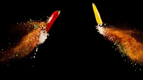 Exotic Spices collide on black background closeup in super slow motion Stock Footage