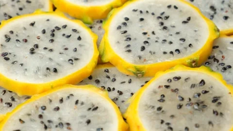 Exotic tropical fruit background with round dragon fruit pitaya slices. Stockbeeldmateriaal 337701702