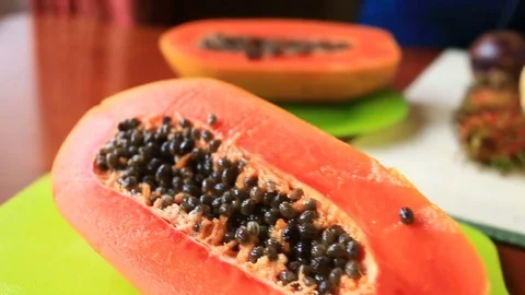 Exotic tropical fruit on table. Thai fruit. Papaya fruit cut in half. close-up Stock Footage 74628264