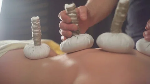 Exotic type of massage - Thai with the use of herbal pouches. Stock Footage